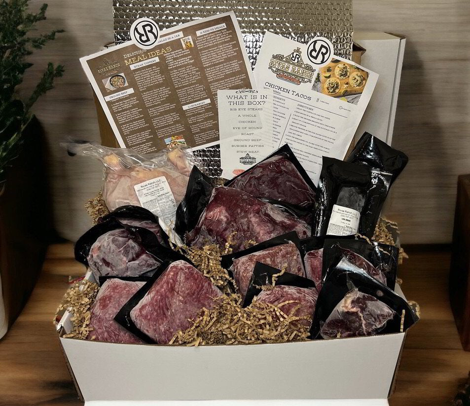 A Rivas Ranch box packed with vacuum-sealed beef cuts, a whole chicken, recipe cards and a what's-in-this-box list